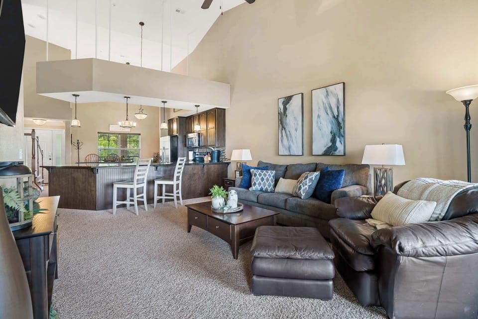 Living room with balcony access, sofa sleeper, and Smart TV