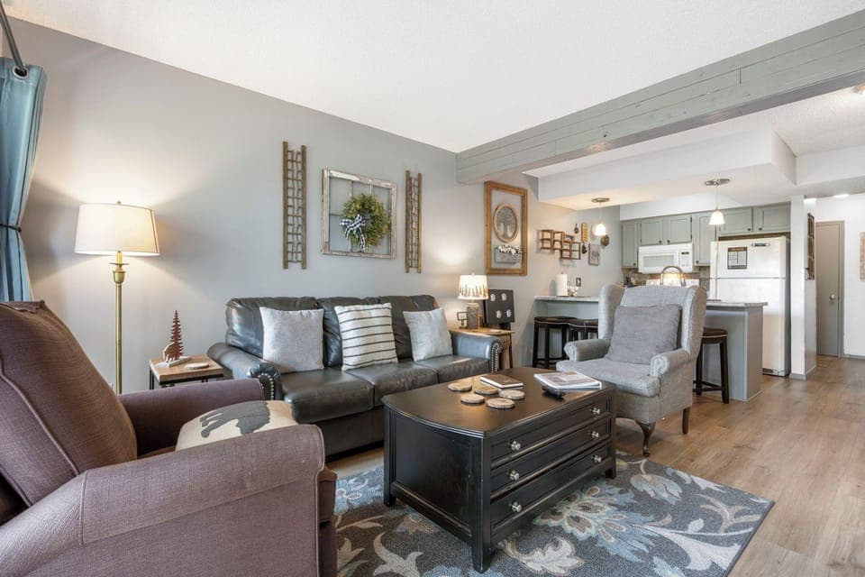 Open living space with Queen sofa sleeper, TV, and deck access