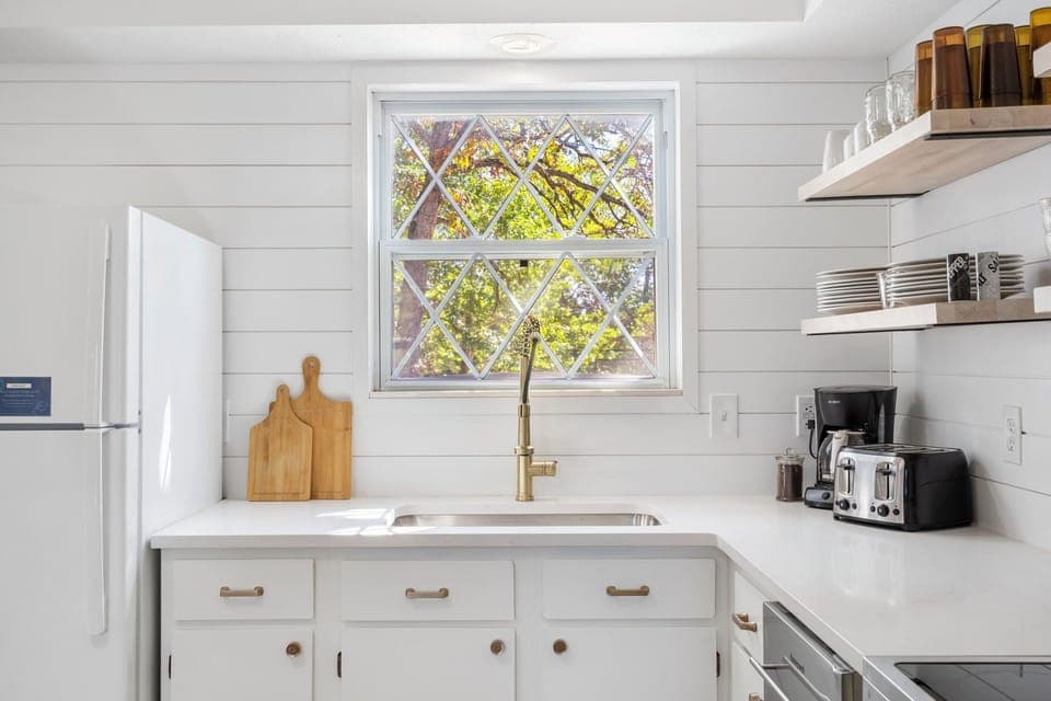 The bright, airy kitchen offers ample space & all the comforts of home