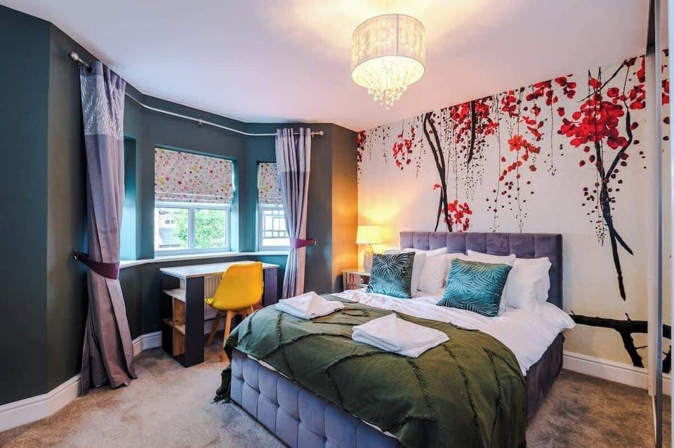 Large double bedroom with dedicated workspace and private ensuite bathroom.