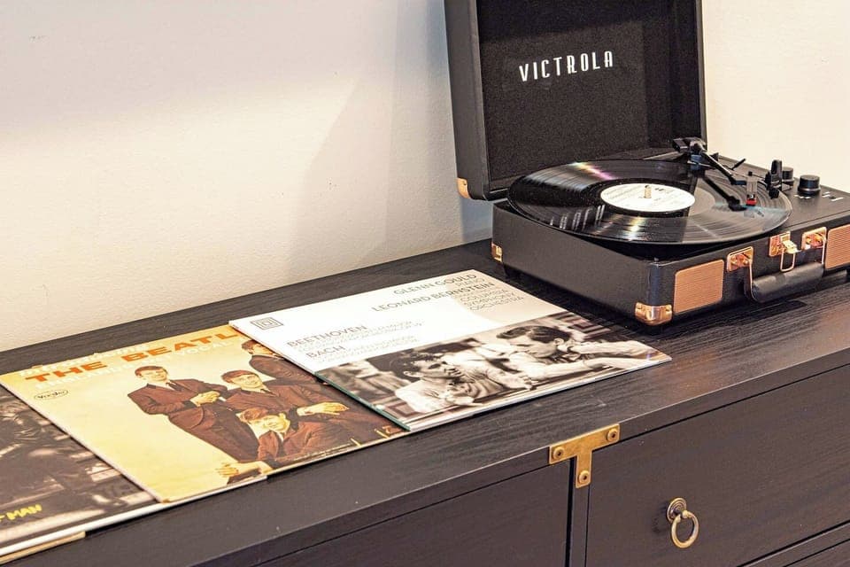 Get lost in the timeless charm of music with a retro record player and a curated vinyl collection. A perfect touch for a cozy, nostalgic evening.