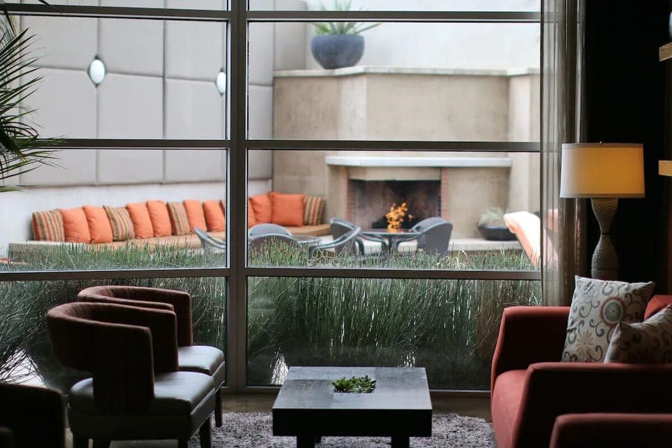 Settle into cozy seating overlooking a glowing outdoor fireplace.