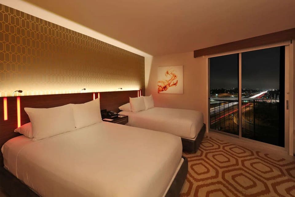 Unwind at night with twin beds and sparkling skyline views