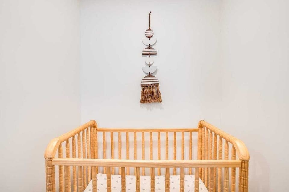 Crib ready for a baby or toddler.  This bedroom is in the  basement, so it can be dark and quiet! 