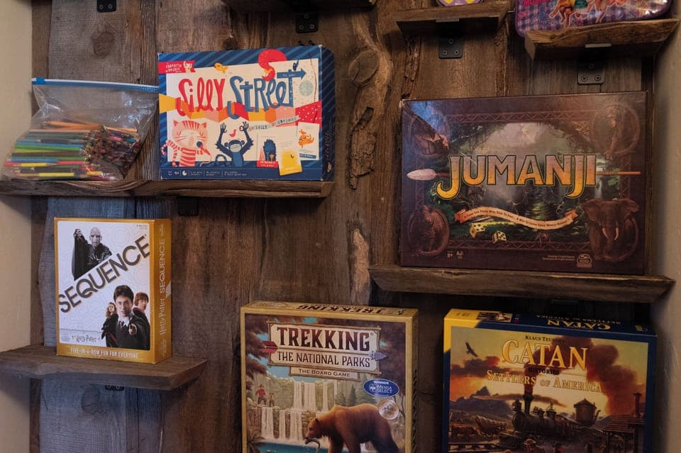 - Game nook with board games for fun indoor activities   - Enjoy classics like Jumanji and adventure favorites   - Entertainment for family nights and cozy days in