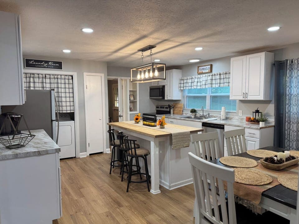 Spacious fully equipped kitchen with island and dinning area.