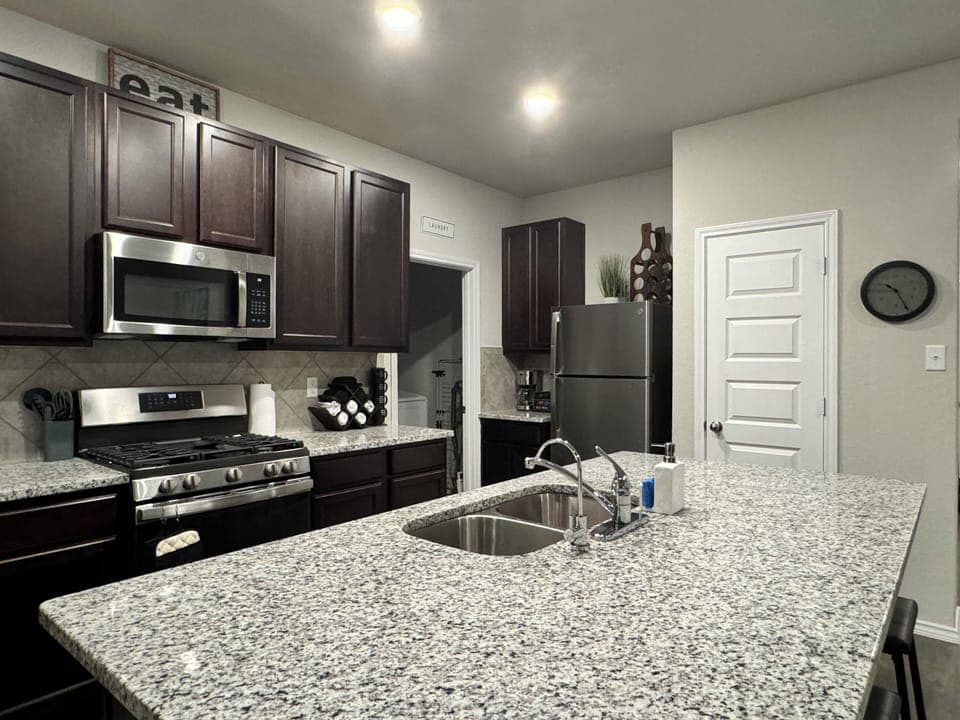 Open kitchen with gas appliances! Fully stocked for cooking needs.