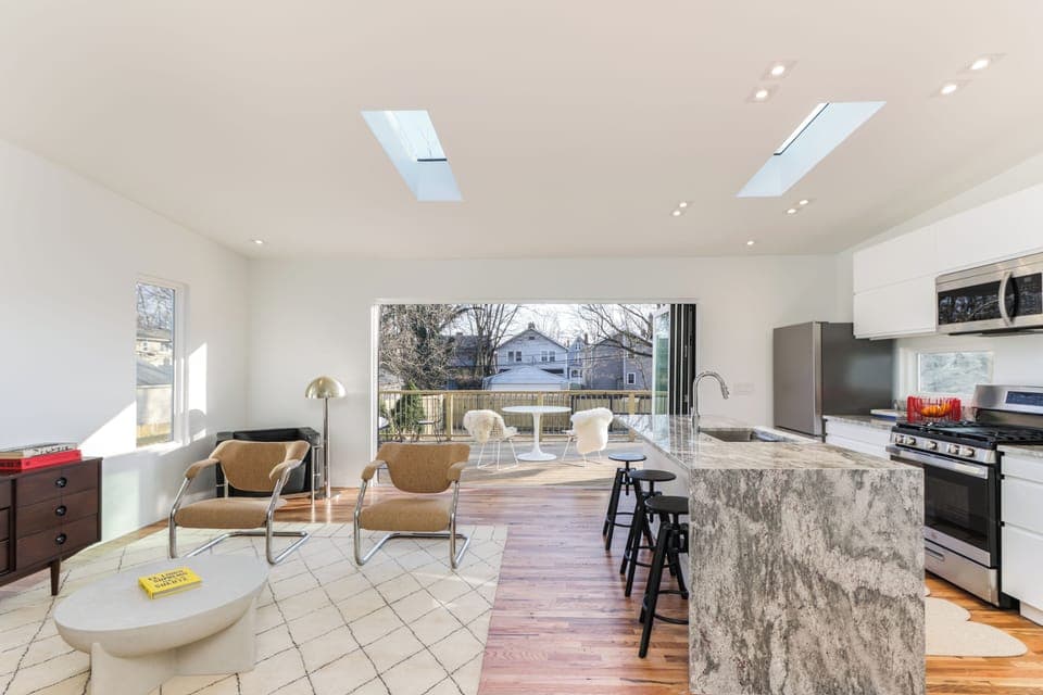 Main living room/kitchen, leading to the deck through the sliding glass doors