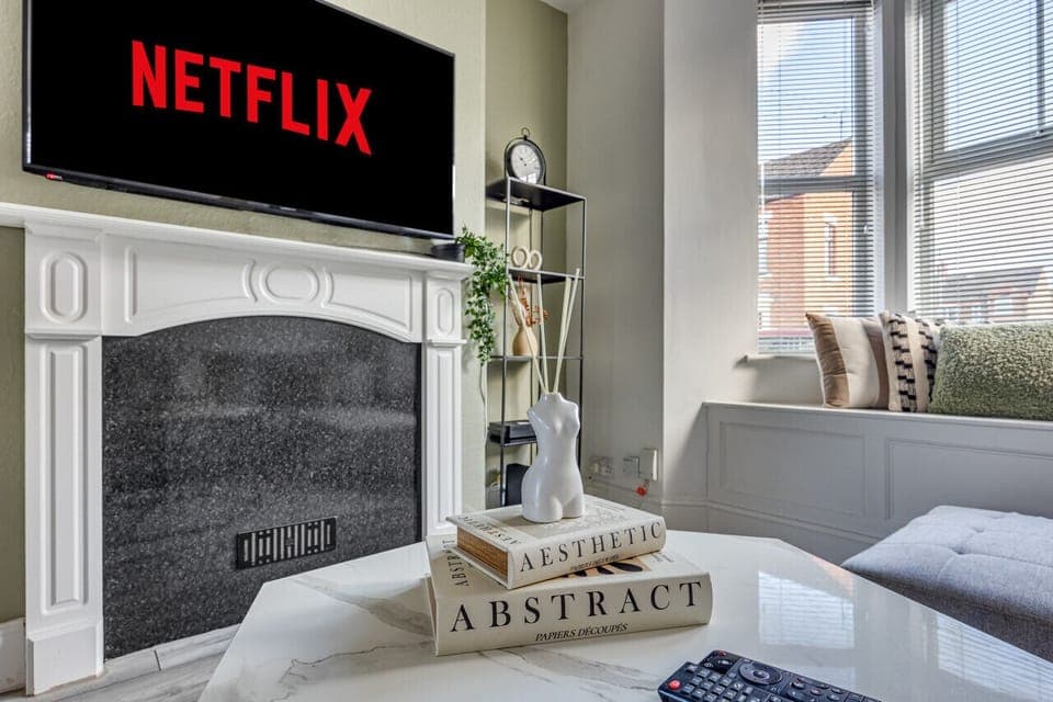 A cosy living room with a large corner sofa, 50'' Smart TV with Virgin and Netflix subscription included and a work desk, perfect for those working or studying from home.