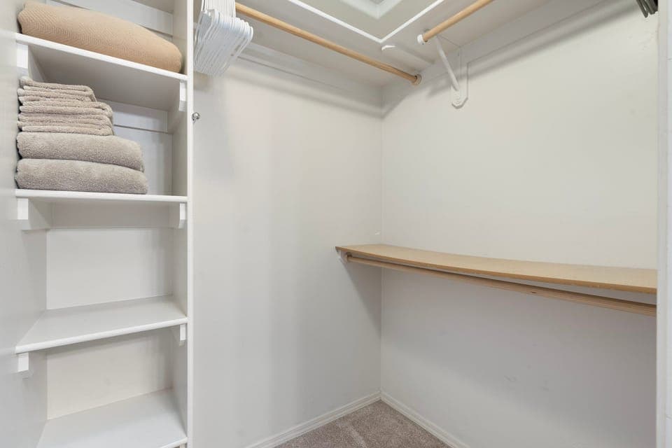 Walk-in closet available in the primary upstairs bedroom w/ extra bedding/towels