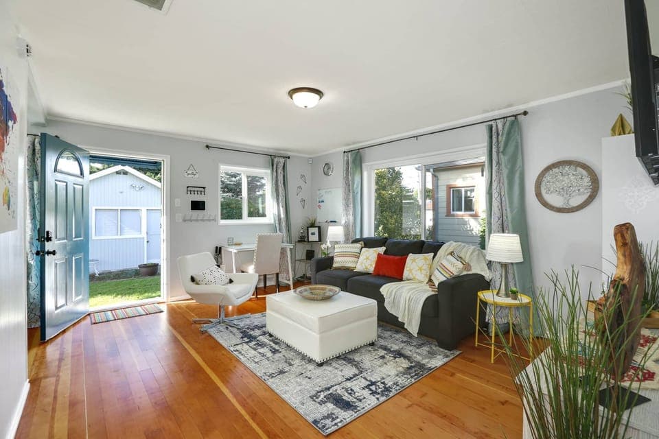 Relaxing bright and spacious living room with comfy sofa, seating and Smart TV