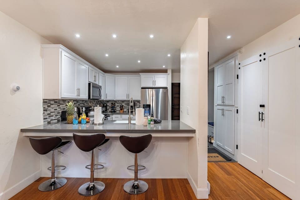Sleek kitchen with barstool seats.