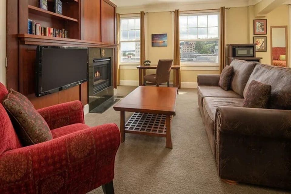 Gather by the fireplace in a spacious living room retreat.