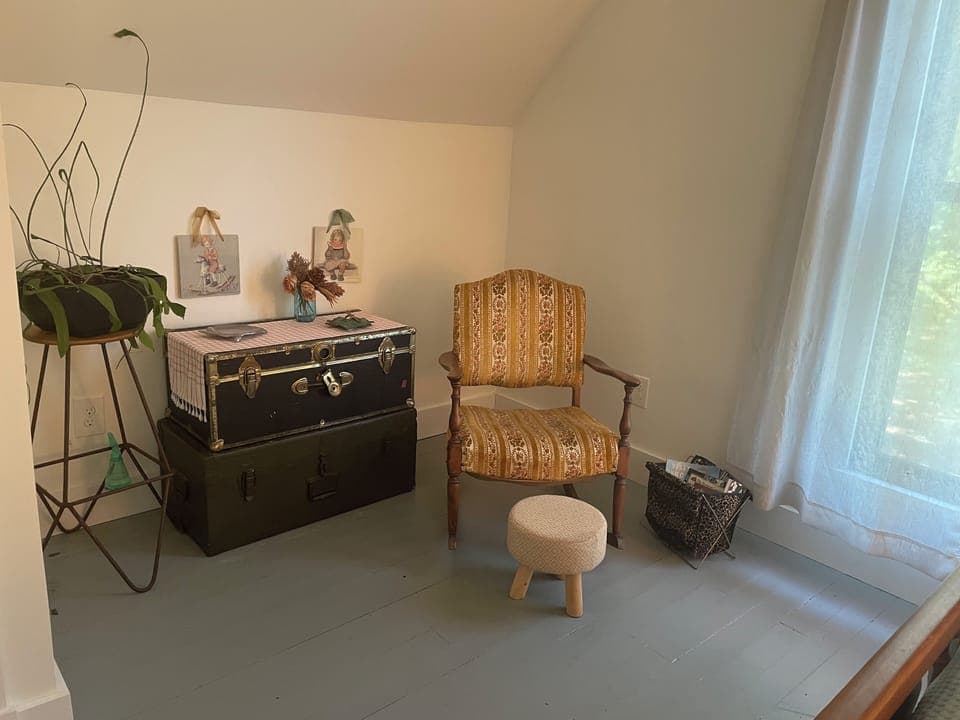 Upstairs bedroom sitting area with magazines and books