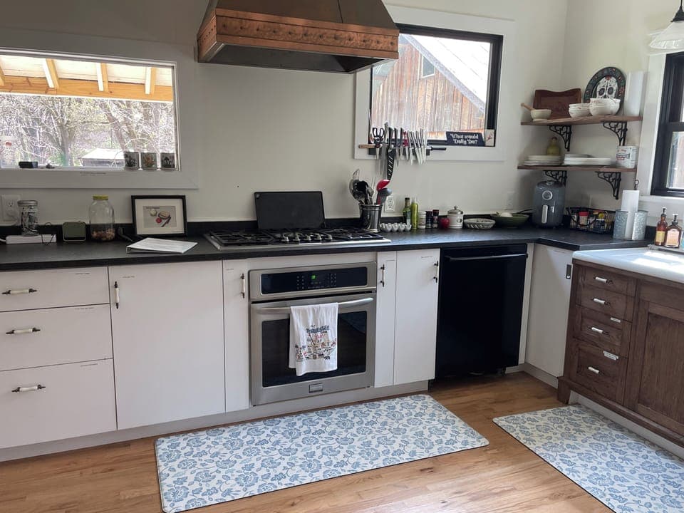 Thermador gas stove &  oven, dishwasher & serving ware.