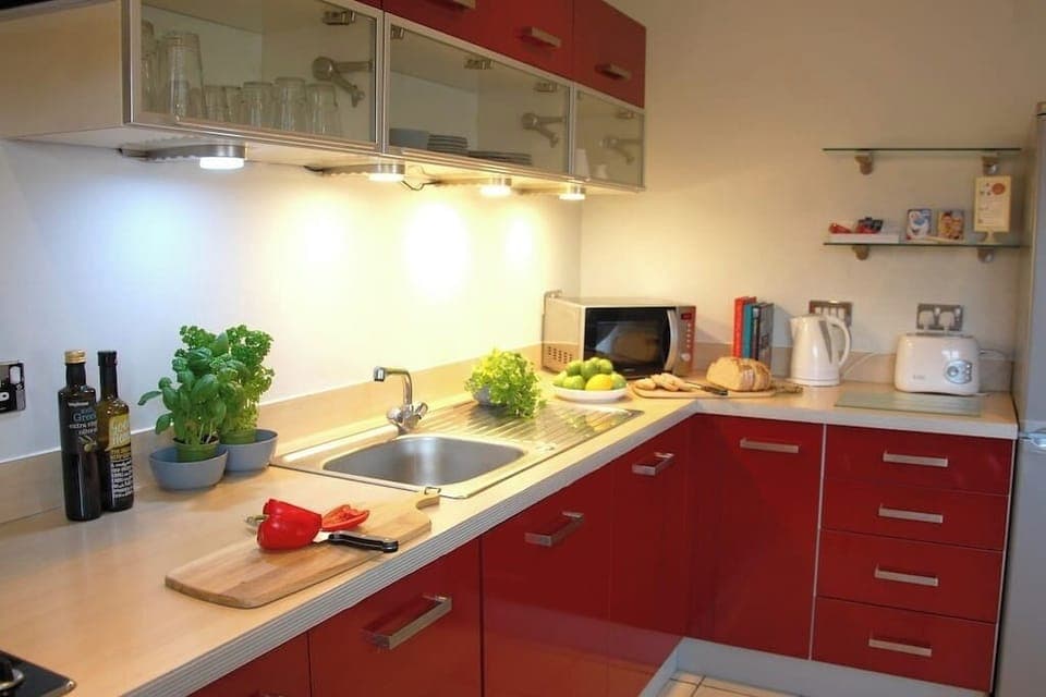 Fully equipped kitchen with washer/dryer, dishwasher, oven/hob, microwave, kettle, toaster, crockery/cutlery.