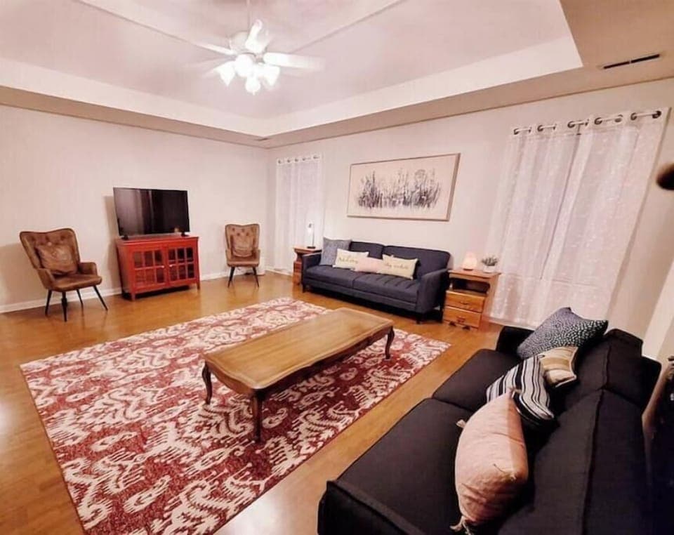 Spacious living room with smart TV, and 2 sofa beds