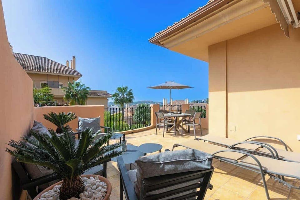 Expansive terrace with sun loungers, offering stunning views and a perfect space to unwind.