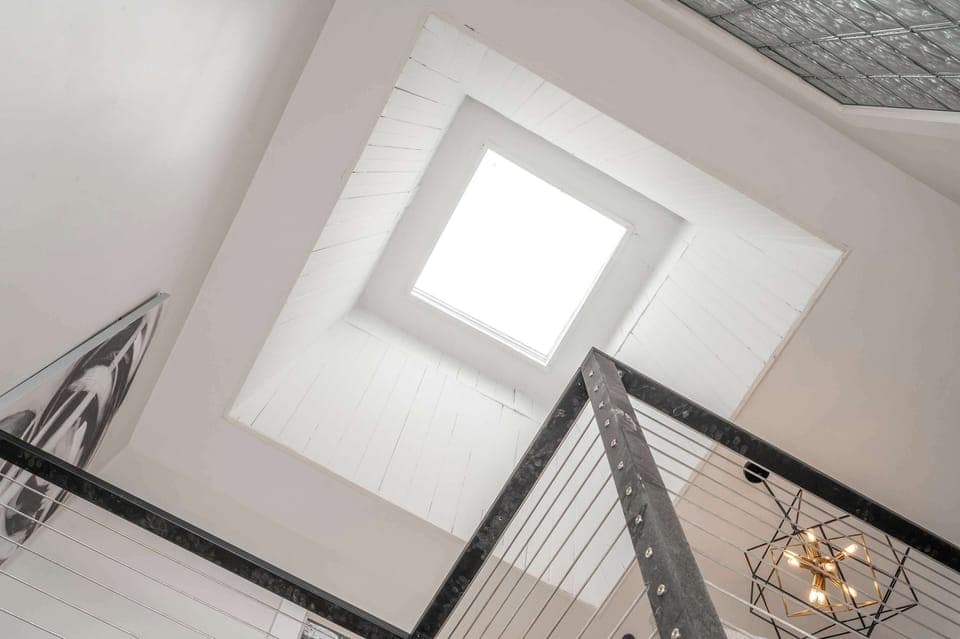 Enjoy the soaring ceilings & wide skylight in the building stairwell