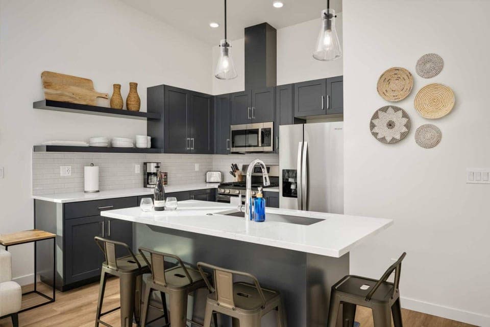 The kitchen is a hub of culinary activity, adorned with sleek countertops, stainless steel appliances, and an array of neatly organized utensils.