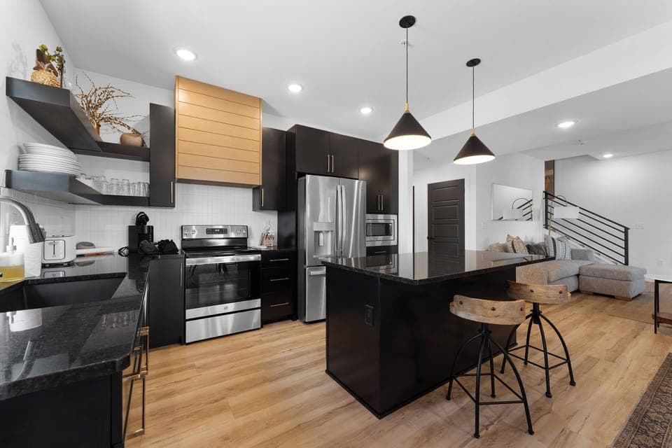 Large gourmet stocked kitchen with island and large dining area for cooking and sharing meals together