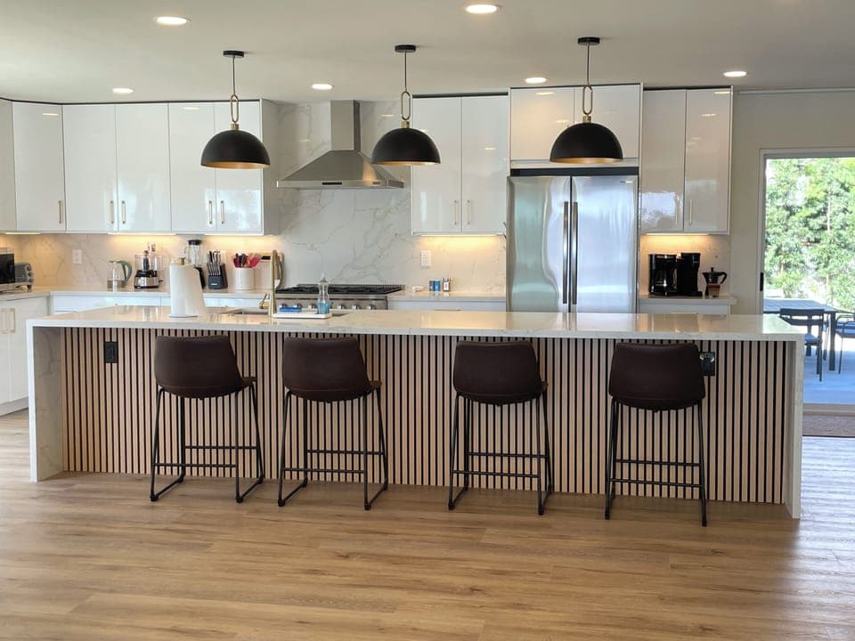 GOURMET KITCHEN with huge island, open to the family room, and the back-yard