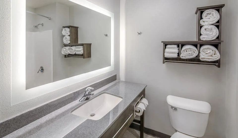 Rinse off comfortably in a spotless, well-lit bathroom.