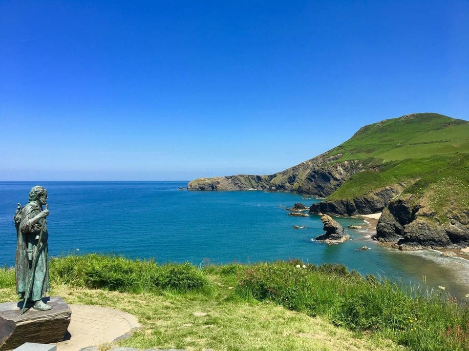 Statue of St Crannog overlooking the beach at Llangrannog