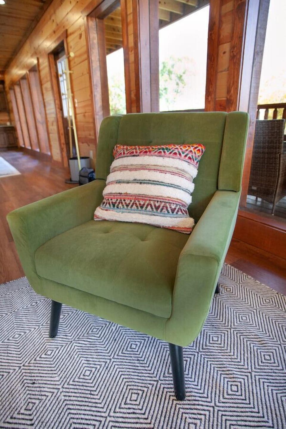 Relax in style with this vibrant accent chair, perfect for cozy cabin moments.