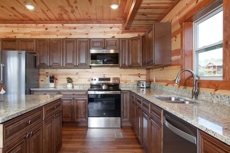 Fully equipped modern kitchen with granite countertops and rustic cabin charm