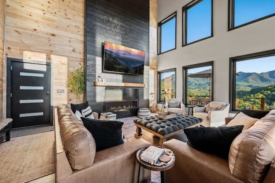 Expansive windows showcase breathtaking mountain views from this stylish living room.