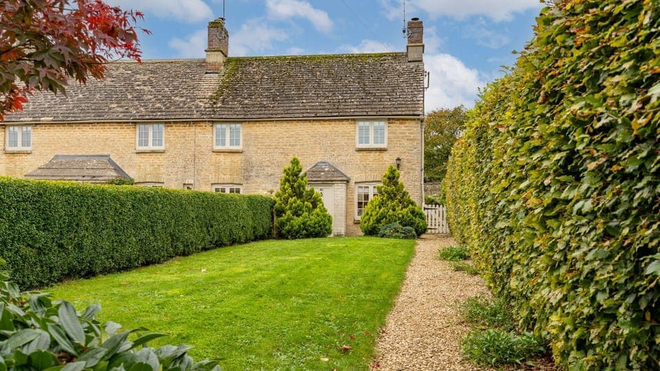 Golden Cotswold stone welcomes you at the end of the garden path