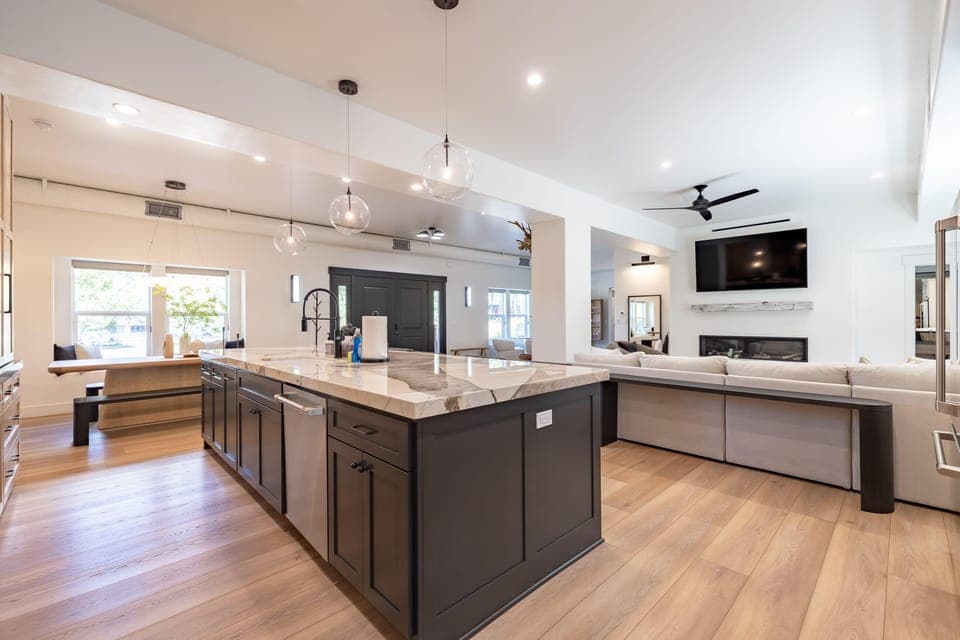 Open concept living area with gas fireplace, smart TV, and chef's kitchen