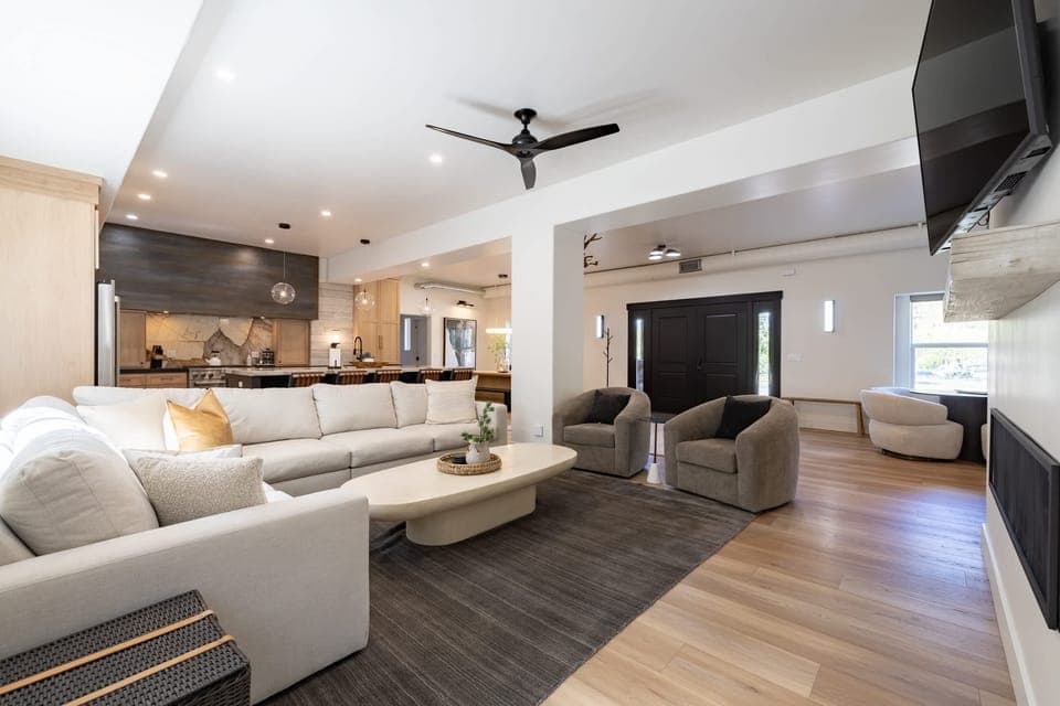Open concept living area with gas fireplace, smart TV, and chef's kitchen