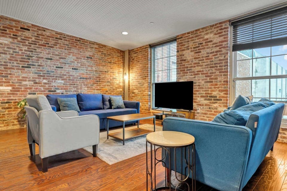 Living Room: Enjoy this comfortable living space with large windows, a flat-screen TV, and plush seating perfect for unwinding after a day of exploring.