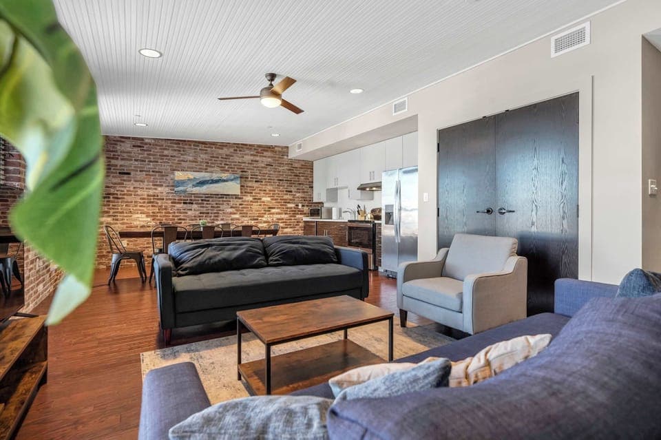 Living Room: Enjoy this comfortable living space with large windows, a flat-screen TV, and plush seating perfect for unwinding after a day of exploring.