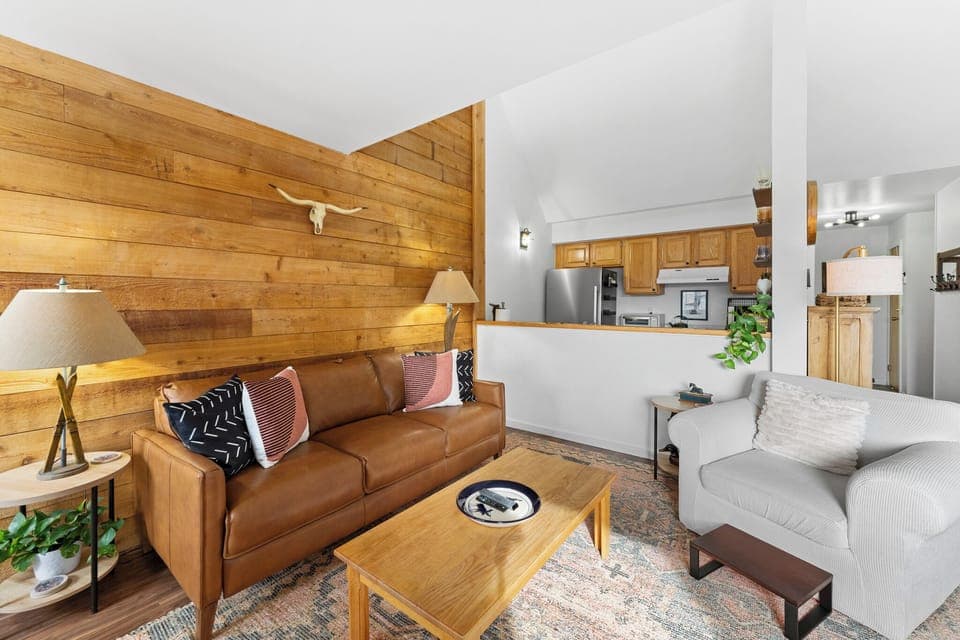 Living area with queen sleeper sofa, fireplace, and balcony access.