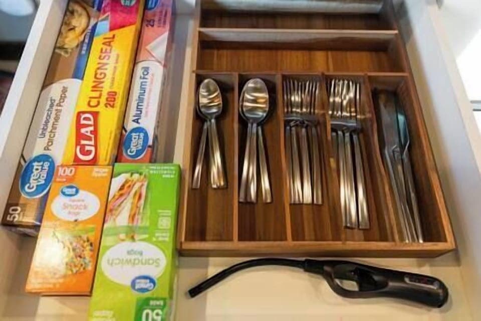 Silverware, essential cooking supplies, and lighter. 