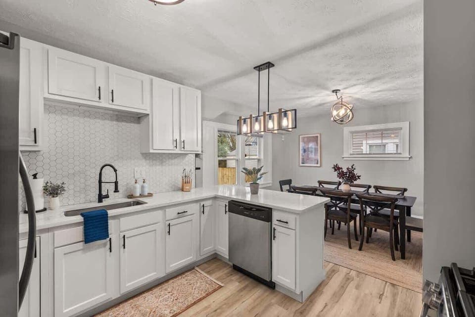 Savor culinary moments in this modern kitchen, seamlessly flowing into an elegant dining area—perfect for gatherings and gourmet experiences.