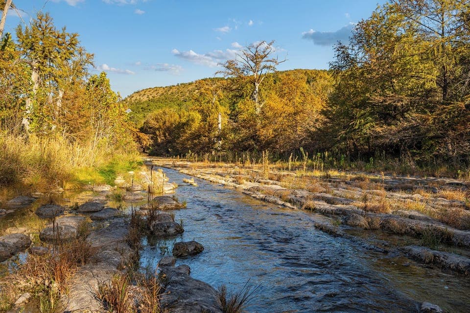 Just steps away from the cabin, the serene Blanco River invites you to relax by its gentle flow.