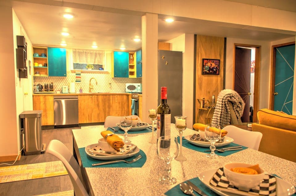 Open concept living, dining and kitchen area with dimmable lights.