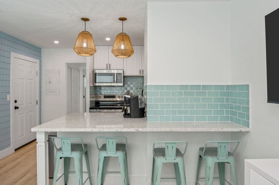 Chic chairs and a modern countertop create a perfect gathering spot.