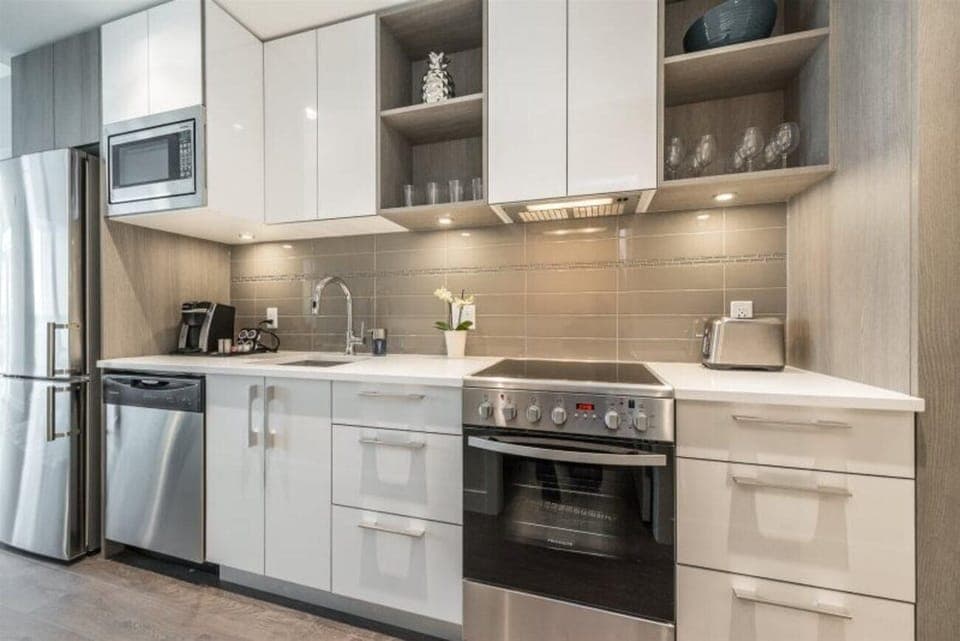 Fully equipped kitchen with sleek appliances and ample storage