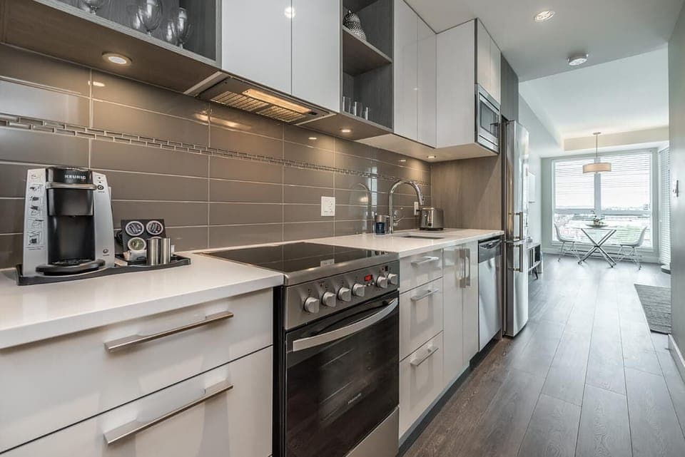 Sleek modern kitchen with stainless steel appliances and bright natural light