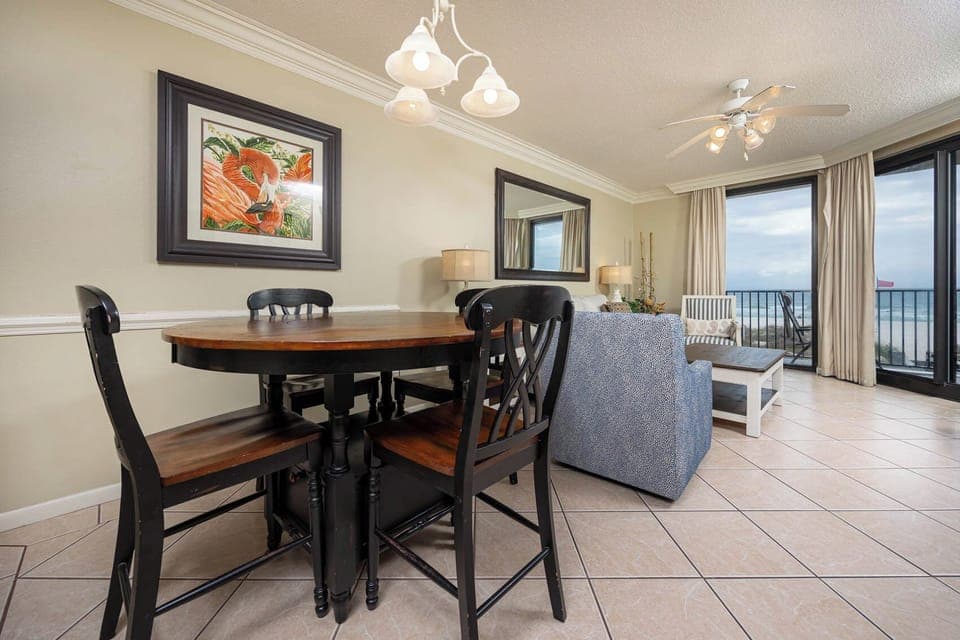 Dine at the round table or relax in the cozy seating while enjoying beach views through large windows