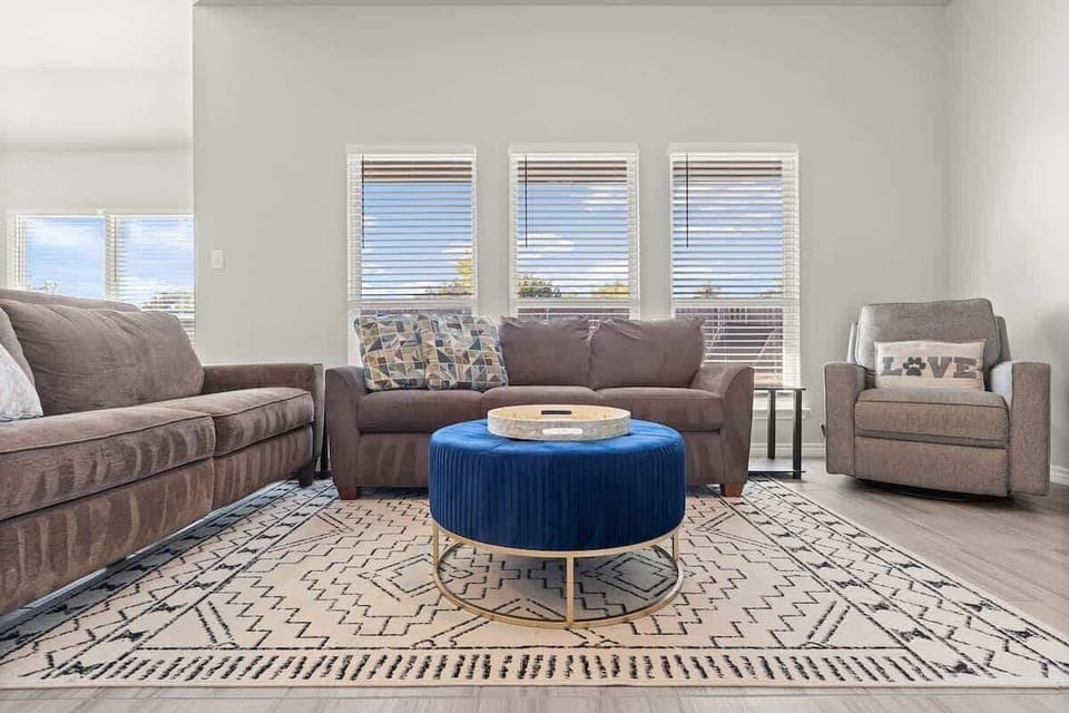 Living Room: Bright and inviting space with plush seating, chic decor, and sunshine-filled views!