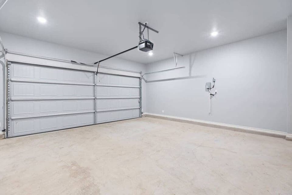Large 2 car garage with Ev charger located on the left wall