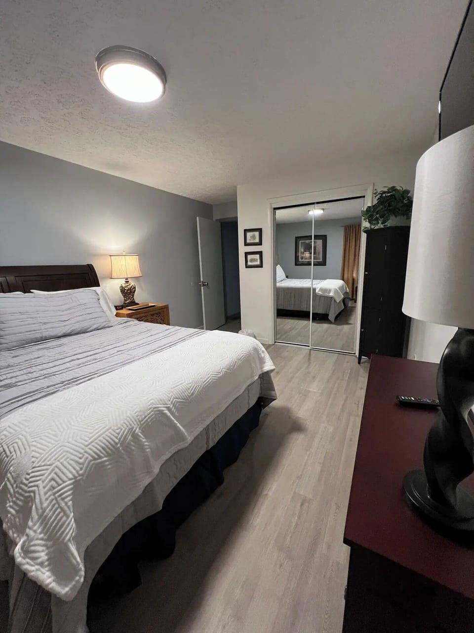 2nd bedroom with new comfortable queen bed with Roku TV and ceiling fan