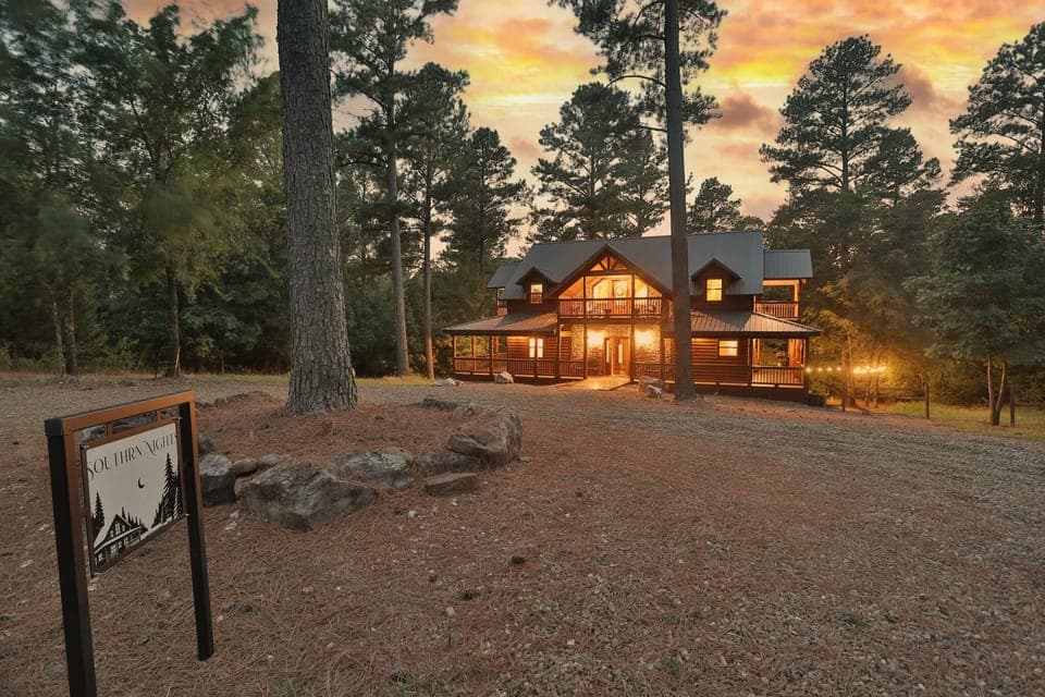 A cozy, glowing retreat nestled among towering pines, perfect for serene getaways.