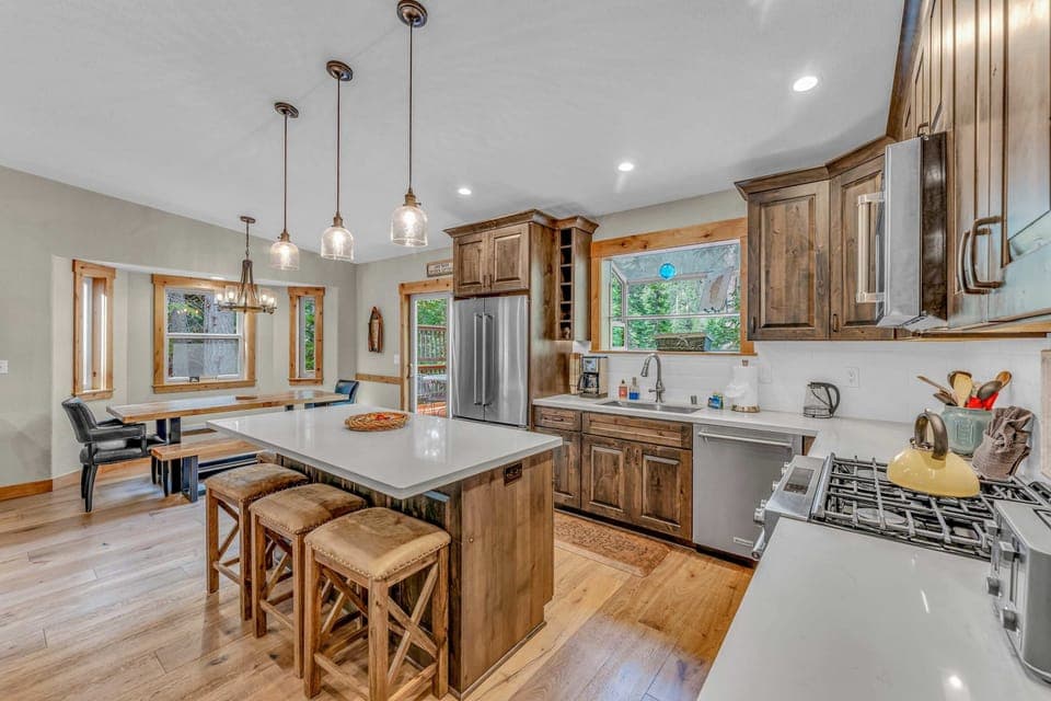 Kitchen: New KitchenAid appliances, drip coffee maker, waffle maker, kitchen island with 3 barstools 
